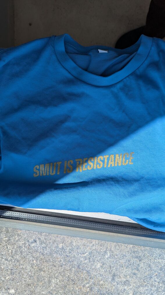 A shirt with the words 'Smut is Resistance' screen-printed on it, in the Heated Rivalry font. click for full resolution.