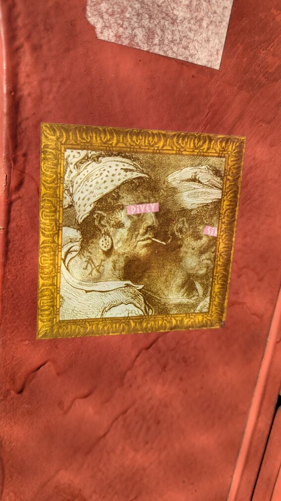 A sticker slap with an old drawing of women smoking, photoshopped into sepia. The logo 'Divey' is covering the eyes of the women. click for full resolution.