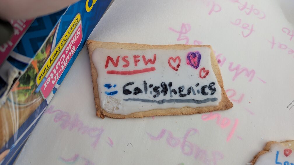 A sugar cookie I made with the words NSFW Calisthenics printed on it, to celebrate my <a href="/play/nsfw_calisthenics/">game</a>. click for full resolution.