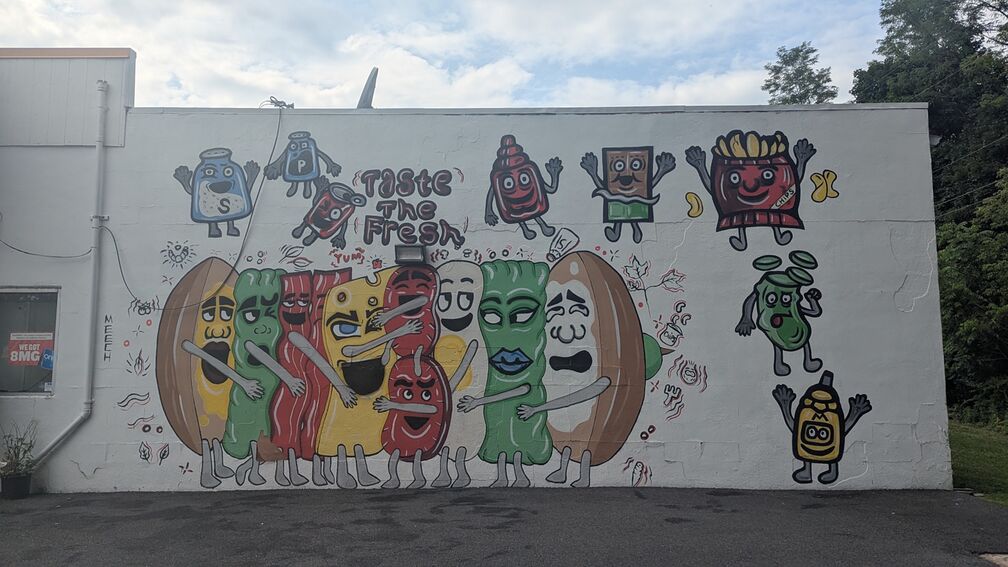 A mural of anthropomorphized sub ingredients hugging each other to make a sandwich. They are way too horny. From a gas station/sub shop in PA. click for full resolution.