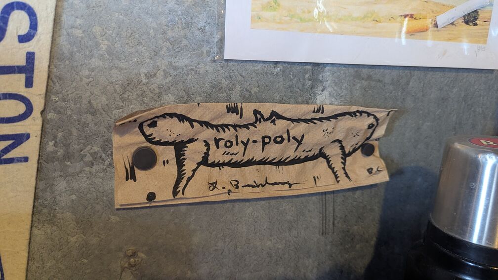 A drawing of a stretched out mammal, like cross between a rat and a weiner dog, titled roly-poly. From Roly-Poly Coffee Co in Bozeman, MT. click for full resolution.