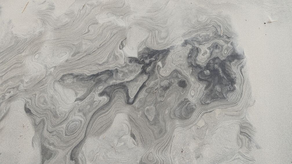 a striking pattern of black sand, found on a beach in SC. click for full resolution.