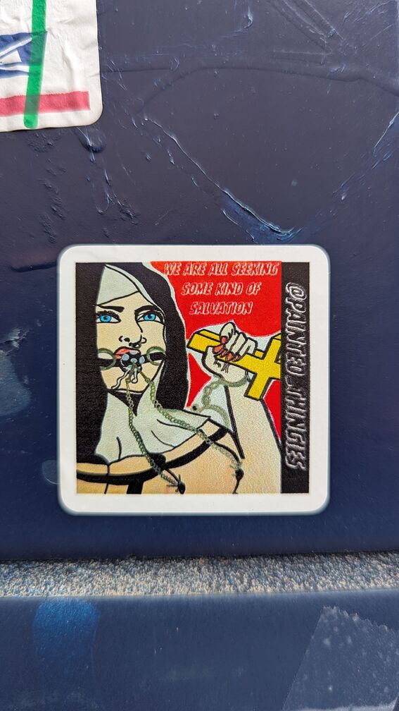 a ball gagged nun with the text 'we are all seeking some kind of salvation' click for full resolution.