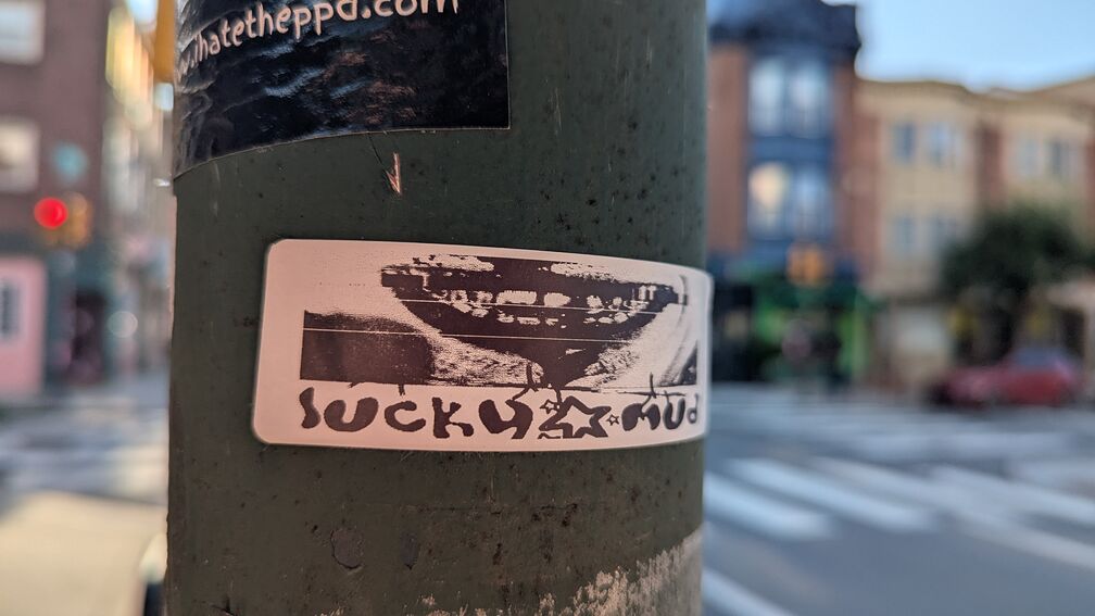 a macarbe smile. text that says: suck u mud click for full resolution.