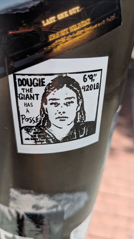 a black and white drawing of a man's face and torso. Text reads: Dougie the giant has a posse, 6'9'', 420lb click for full resolution.