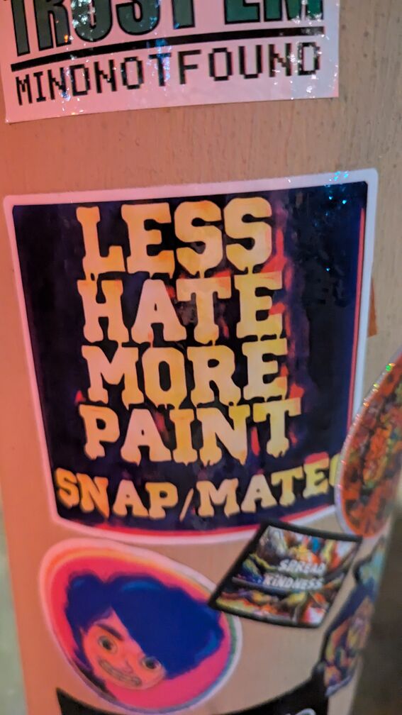 a sticker that says: less hate more paint click for full resolution.