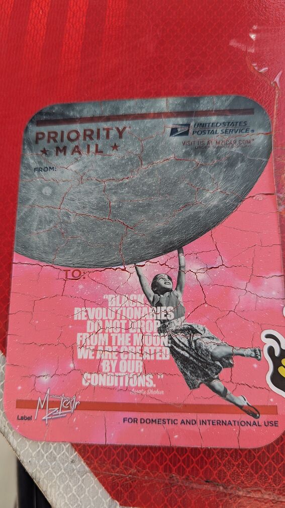 A Priority Mail sticker that reads: Black Revolutionaries Do Not Drop From The Moon. We Are Created By Your Conditions - Assata Shakur. It features a picture of a young black girl dangling down from the moon with her arms outstretched. click for full resolution.
