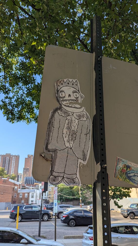 A large cutout of a caroon zombie king. Worn down by the elements over time. click for full resolution.
