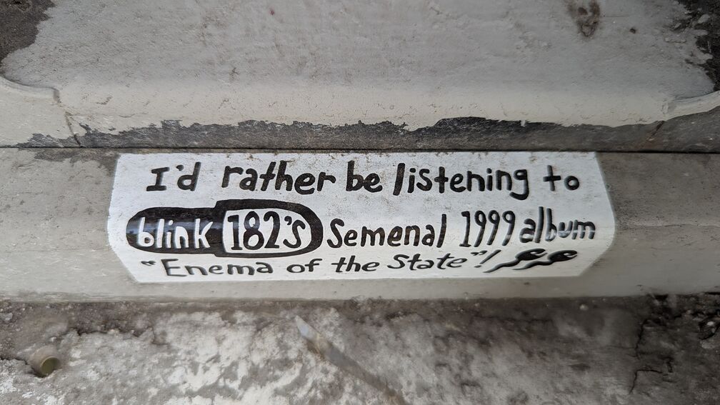 A sticker that reads: I'd rather be listening to blink182's semenal 1999 album 'Enema of  the state'! click for full resolution.