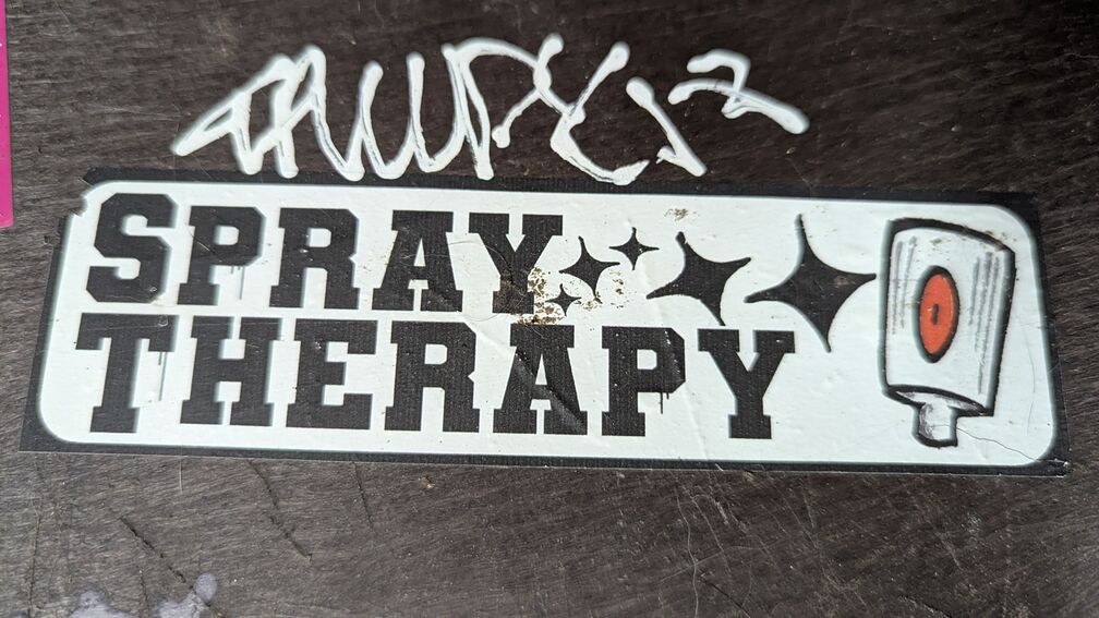 A sticker that says: Spray Therapy. click for full resolution.