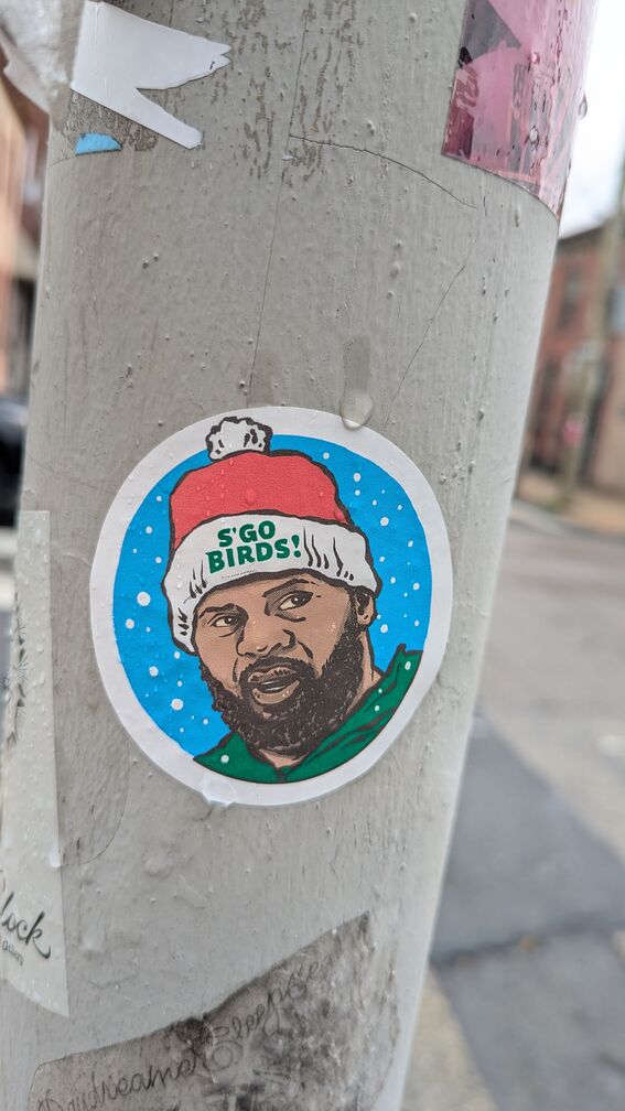 A drawing of a man wearing an Eagles jersey and a santa hat that say "S'Go Birds" on it. click for full resolution.