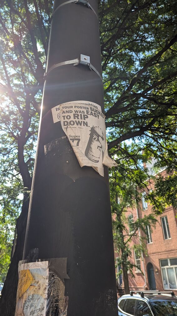 A poster that looks like an old timey ad. It reads: Your poster sucked and was easy to rip down, next time try Super 77. Next to the text is a photo of a can of super 77 glue. click for full resolution.