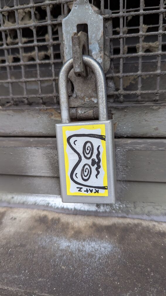 a padlock with a sticker of a confused cat head on it click for full resolution.