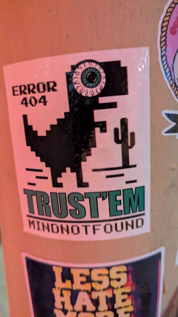the chrome dinosaur with a giant bloodshot eye pasted on it. it reads: error 404, Trust'Em. By MindNotFound. click for full resolution.