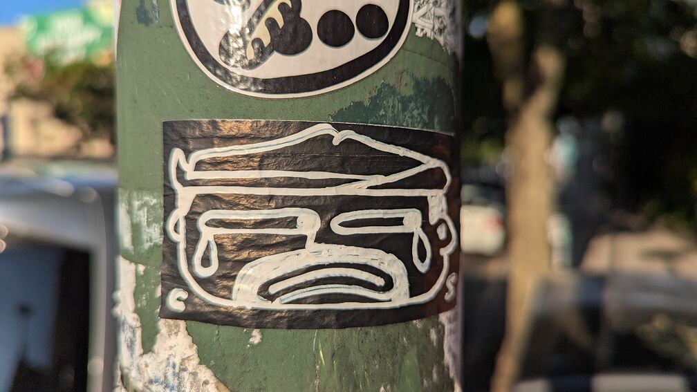 A stretched out black and white sticker of a man crying click for full resolution.