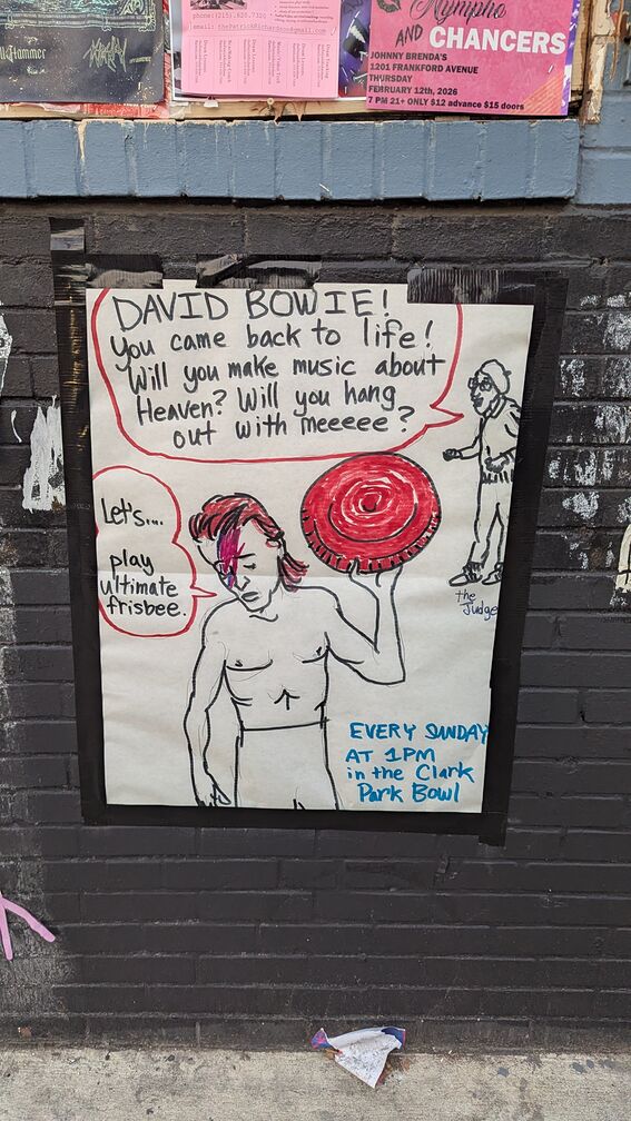 A poster with a picture of David Bowie holding a frisbee taking the foreground. A character in the background says: 'David Bowie! You came back to life! Will you make music about Heaven? Will you hang out with meeeee?' David Bowie responds: 'Let's... play ultimate frisbee.' Text on the right of the poster reads: 'Every Sunday at 1PM in the Clark Park Bowl.' click for full resolution.
